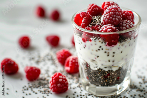 Chia seeds with Greek yogurt and fresh raspberries in a glass