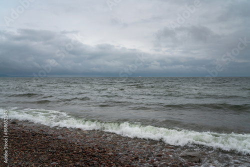 Fototapeta Naklejka Na Ścianę i Meble -  View of the Baltic Sea and a pebble beach on a cloudy summer day, Svetlogorsk, Kaliningrad region, Russia