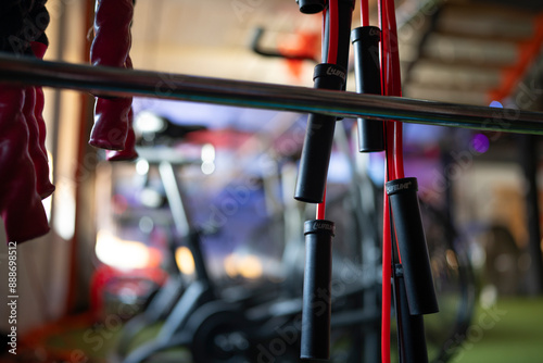 Indoor performance fitness studio lifting rack closeup with jump ropes and heavy ropes in focus.