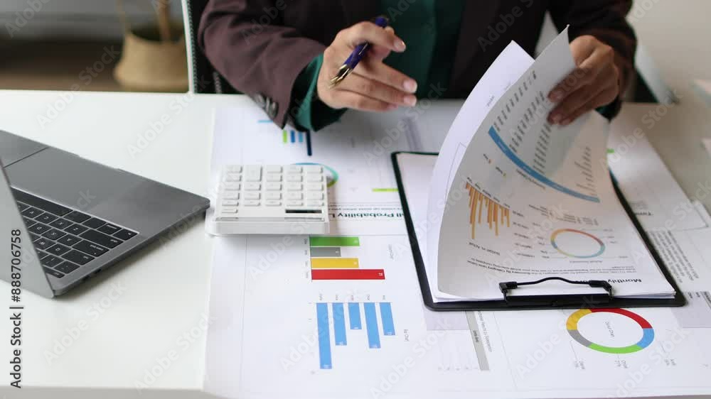 Accountant woman calculating finances in office. Professional female accountant working in an office, calculating finances, writing on documents, and using a laptop. Accountant woman calculating finances in office. Professional female accountant working in an office, calculating finances, writing on documents, and using a laptop.