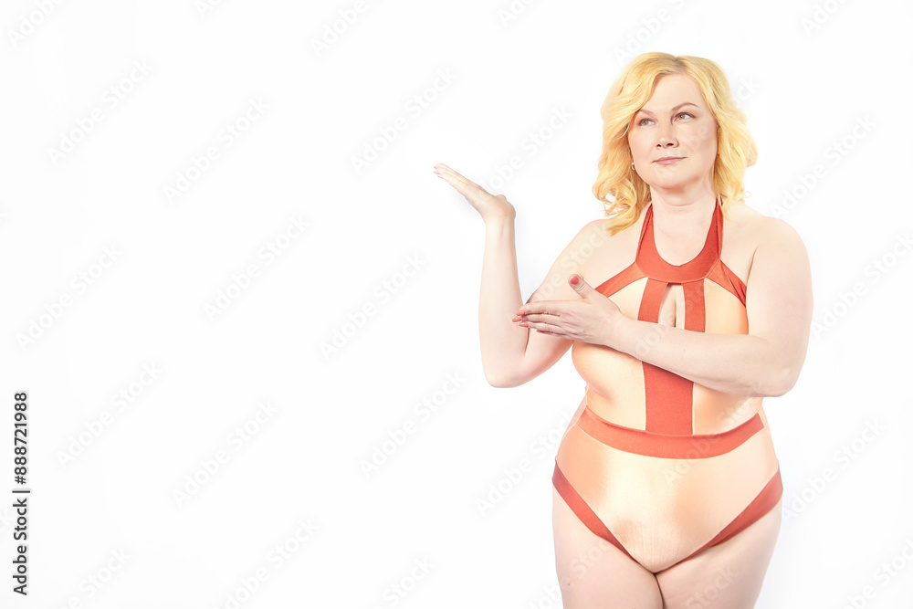 Funny cute mature adult woman with blonde hair in a swimsuit on a white background. Fat middle-aged lady poses in underwear in studio. The concept of body positivity Funny cute mature adult woman with blonde hair in a swimsuit on a white background. Fat middle-aged lady poses in underwear in studio. The concept of body positivity