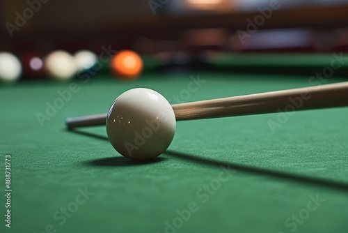 Using the billiard bridge a cue stick prods the white ball photo