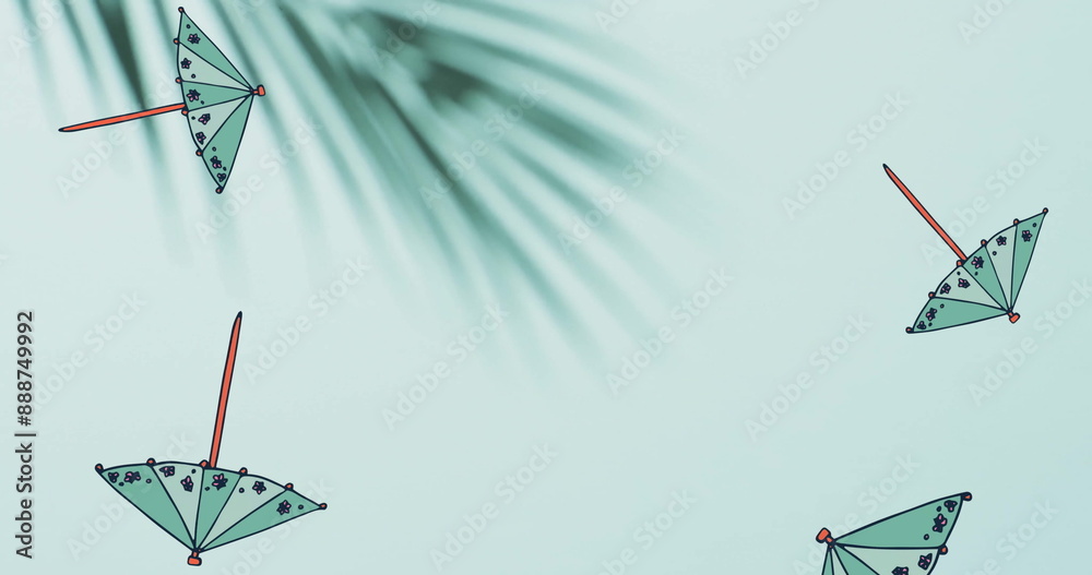 Naklejka premium Composition of green cocktail umbrellas falling over palm tree leaves on green background