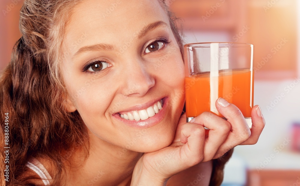 A young happy healthy woman drinks juice. A young happy healthy woman drinks juice.
