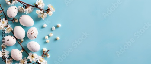  White eggs nestled in a tree branch's crook, surrounded by blossoms and adjacent white flowers