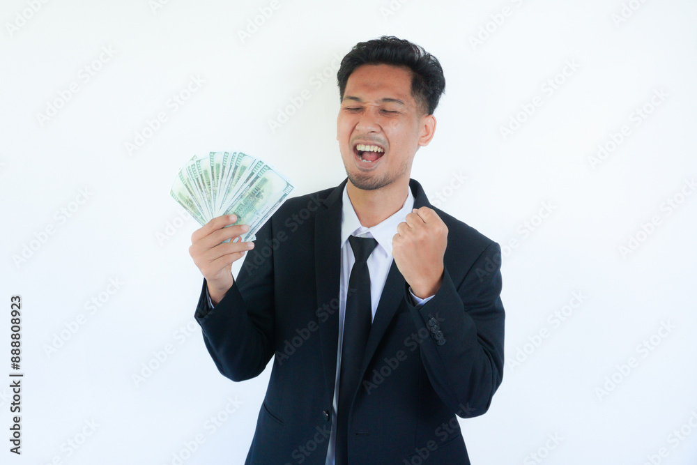 Young asian businessman holding money show fist up apreeciate happy about earn money Young asian businessman holding money show fist up apreeciate happy about earn money