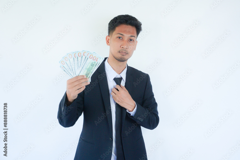 Portrait business man holding cash dollar bills over gray background. Big luck, banner. Dollar cash money concept. Rejoices to win cash. Man hold cash money. Portrait business man holding cash dollar bills over gray background. Big luck, banner. Dollar cash money concept. Rejoices to win cash. Man hold cash money.