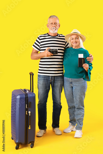 Senior couple with suitcase...