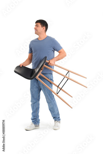Young man carrying stool on...