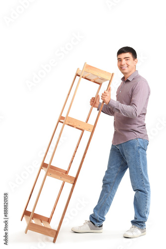 Young man carrying shelf un...