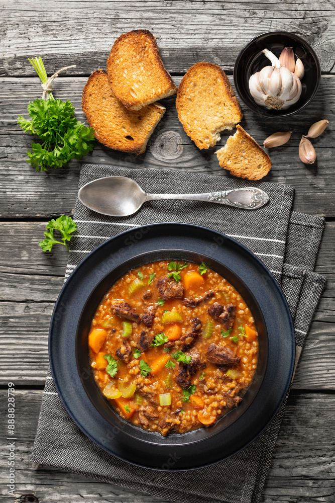 beef barley soup in a bowl, top view