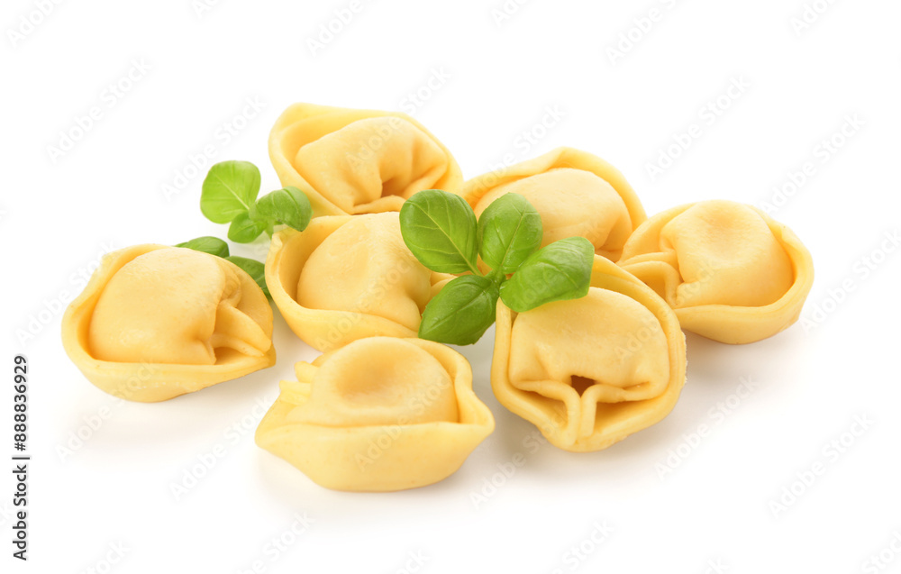 Raw dumplings and basil on white background Raw dumplings and basil on white background