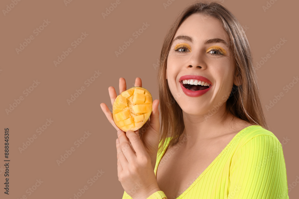 Beautiful young woman with cut sweet mango fruit on brown background Beautiful young woman with cut sweet mango fruit on brown background