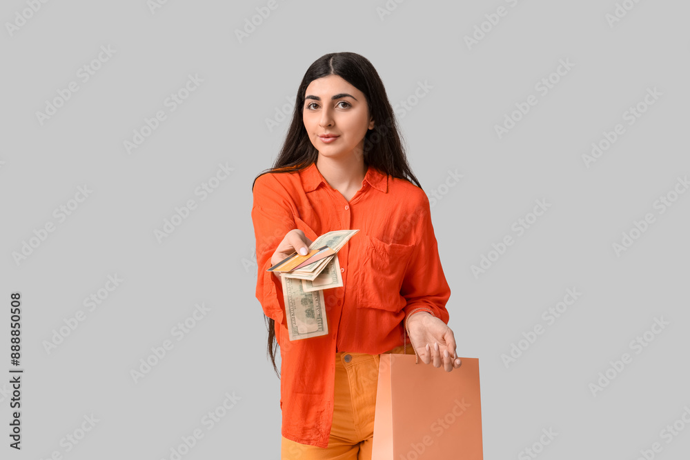 Beautiful young woman with shopping bag, credit cards and money on white background Beautiful young woman with shopping bag, credit cards and money on white background