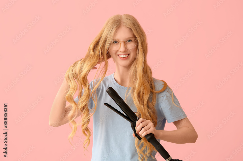 Beautiful young happy woman with modern curling iron on pink background Beautiful young happy woman with modern curling iron on pink background