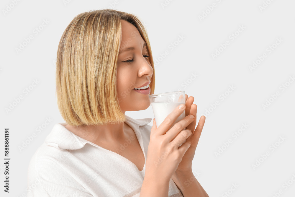 Beautiful young woman with glass of fresh milk on white background Beautiful young woman with glass of fresh milk on white background