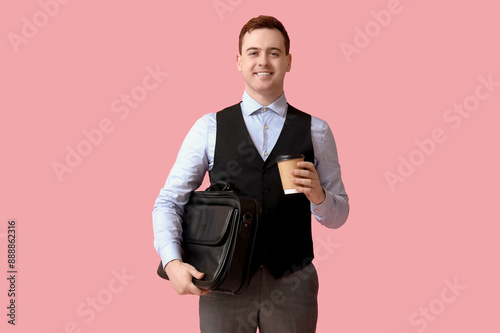Young man holding paper cup...