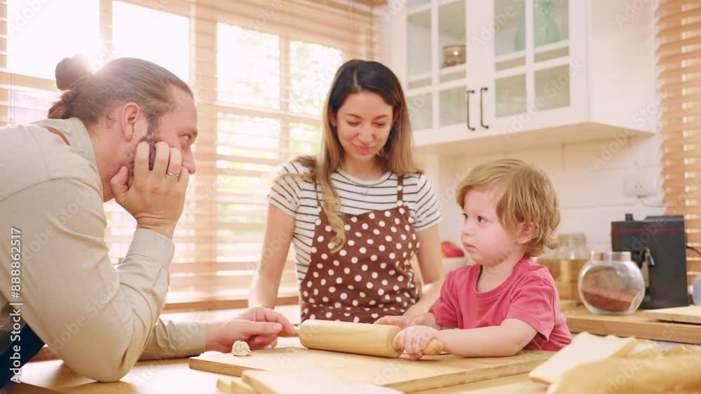 Caucasian attractive couple baking bakery with son in kitchen at home. Caucasian attractive couple baking bakery with son in kitchen at home.