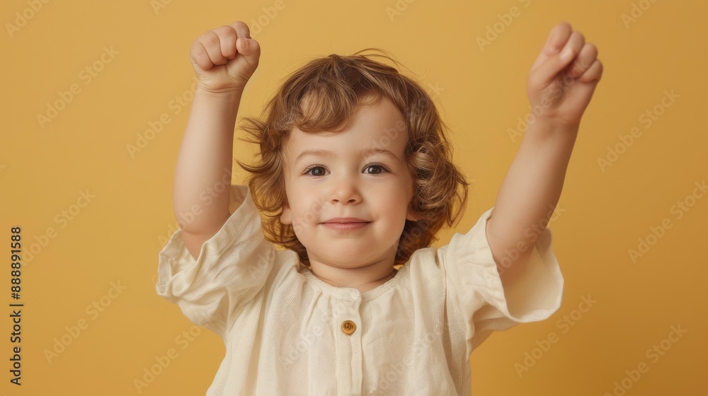 Kid raising hand on beige background Kid raising hand on beige background