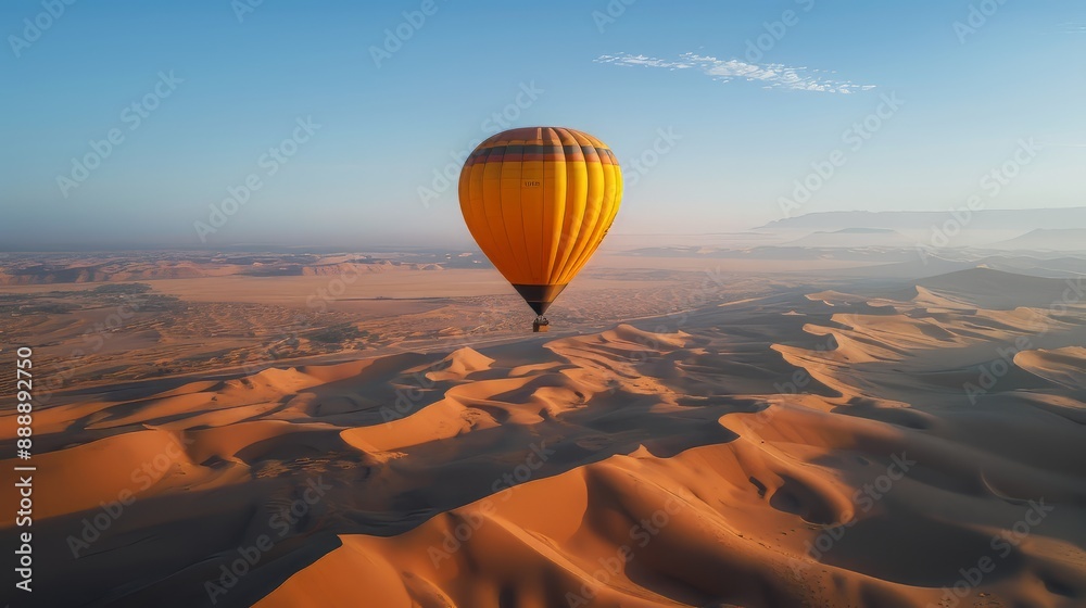 A pink hot air balloon flying over sand dunes with a blue sky with clouds A pink hot air balloon flying over sand dunes with a blue sky with clouds