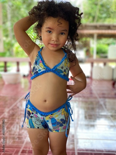 Portrait of a cute Asian little girl in blue swimsuit