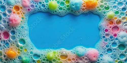 Vibrant frame filled with colorful foam made from soap, shampoo, lotion, and detergent on a soft blue background, highlighting tiny bubbles in water. photo