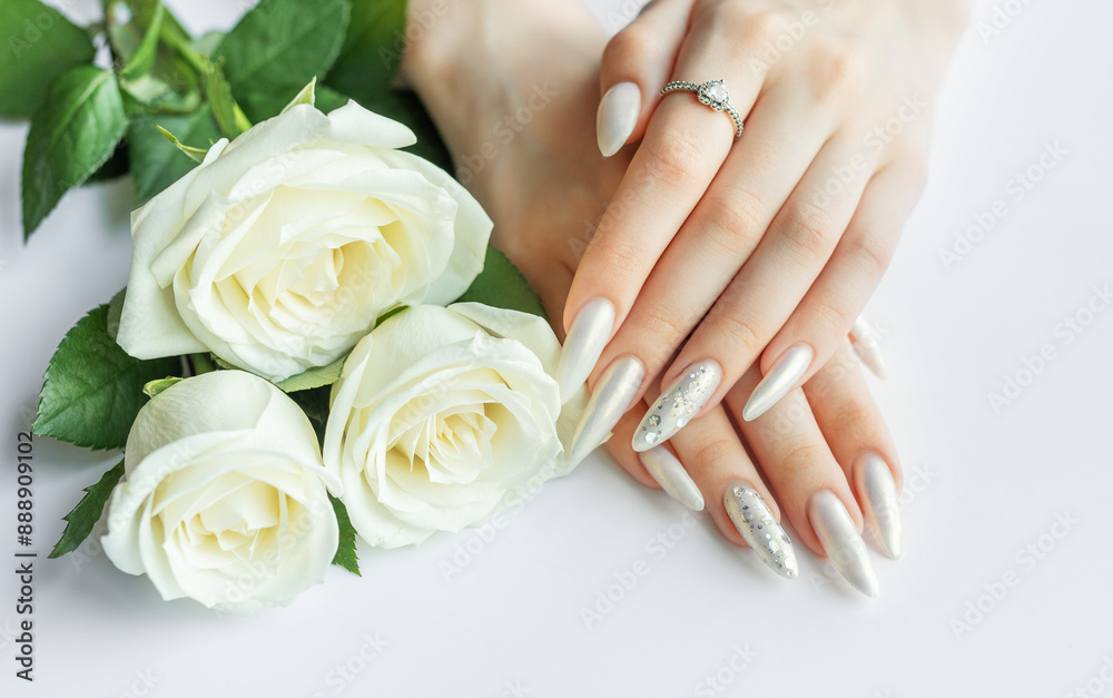 Female Hands on a white background with beautiful pearl manicure Female Hands on a white background with beautiful pearl manicure