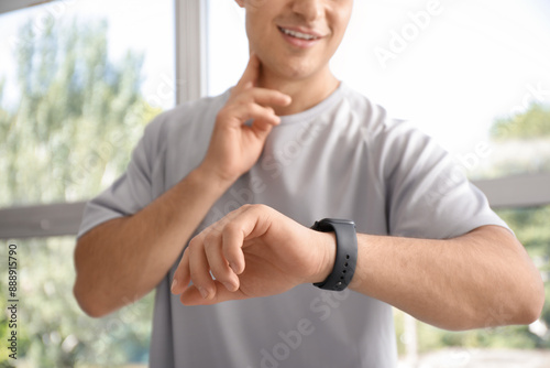 Sporty young man with smart...