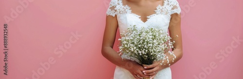 Bride Holding White Babys Breath Bouquet Against Pink Wall