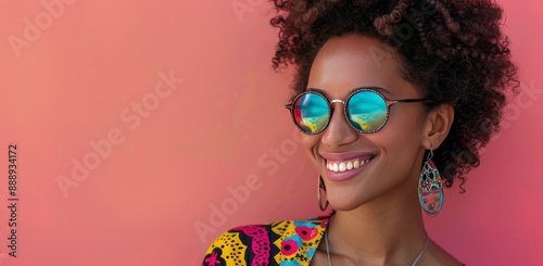 Smiling Woman Wearing Colorful Sunglasses and Earrings Against Pink Background