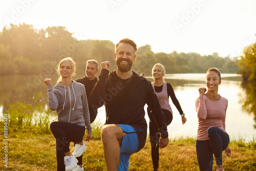 Cuadro en lienzo Portrait of a happy group of people exercising and doing sports and workout in a city park