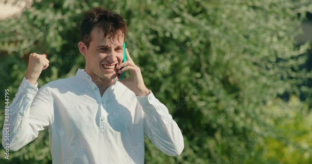 A man getting splashed with water while talking on the phone A man getting splashed with water while talking on the phone