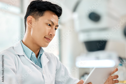 Man, scientist and tablet for medical research, pathology and review in laboratory as employee or staff. Male person, doctor and tech with results, feedback or analysis for science or breakthrough