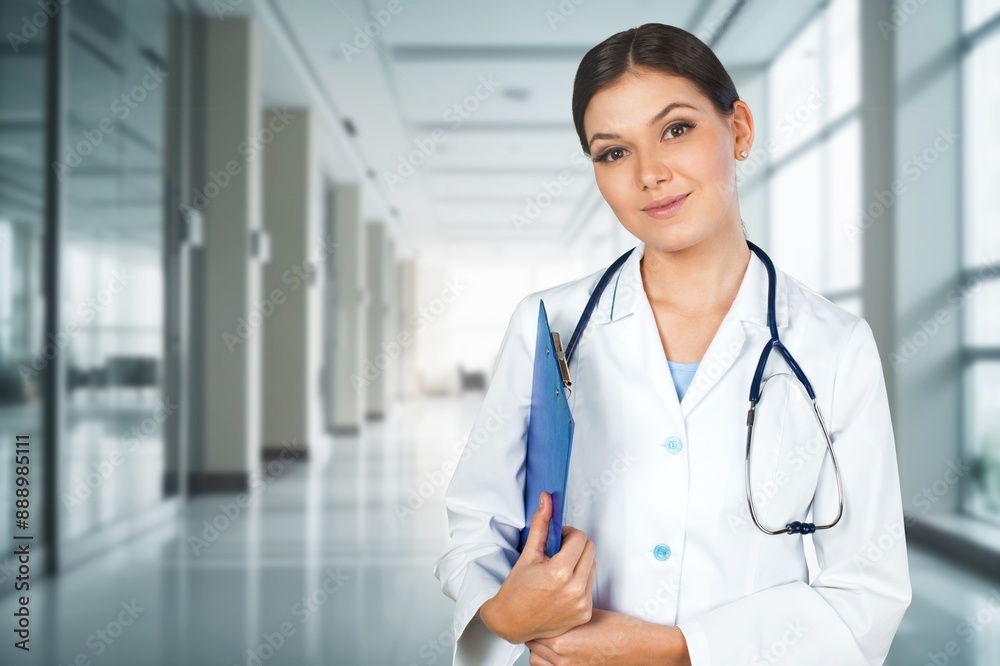 Cheerful millennial doctor in coat at clinic