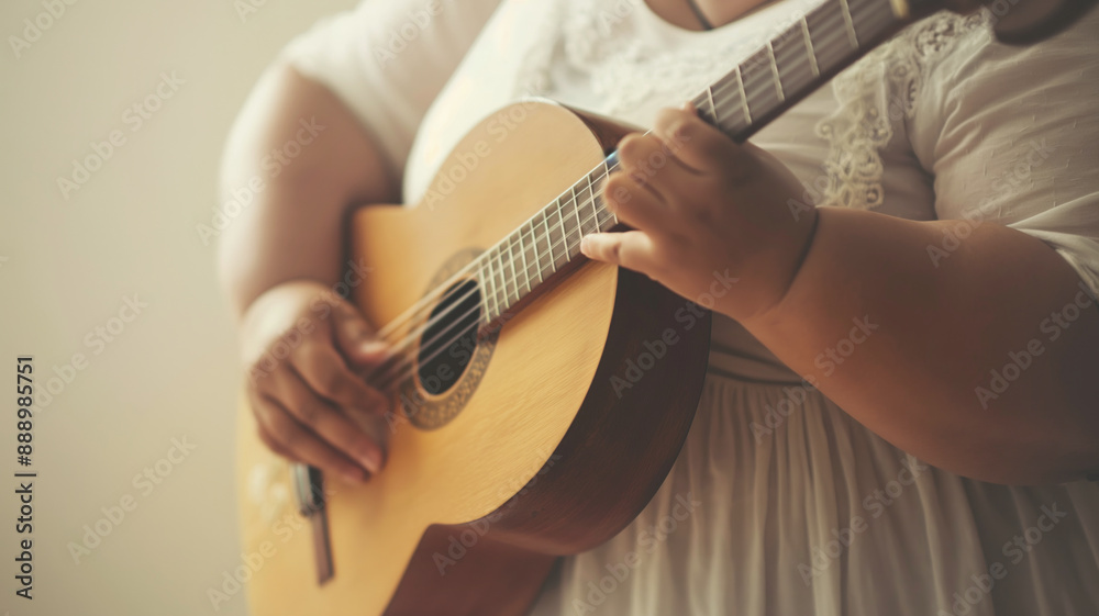 Fototapeta premium Close up of person playing acoustic guitar, hands strumming guitar strings, focus on fingers and instrument, music passion concept