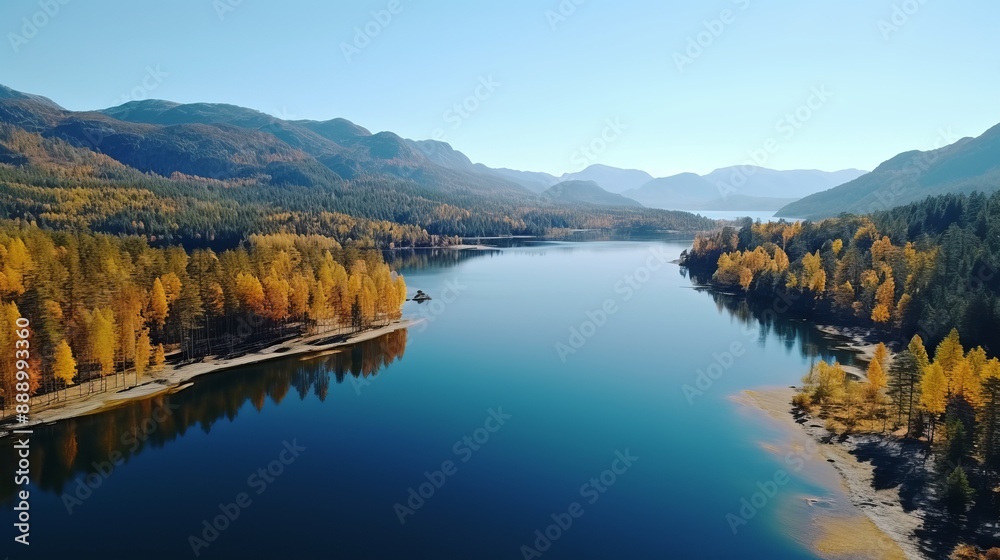 Aerial View of a Stunning Autumn Forest and Pristine Lake with Mountain Backdrop Aerial View of a Stunning Autumn Forest and Pristine Lake with Mountain Backdrop