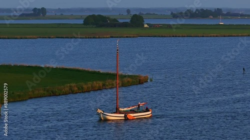 Aerial view of serene lake at dusk with boats, Friesland, Netherlands. photo