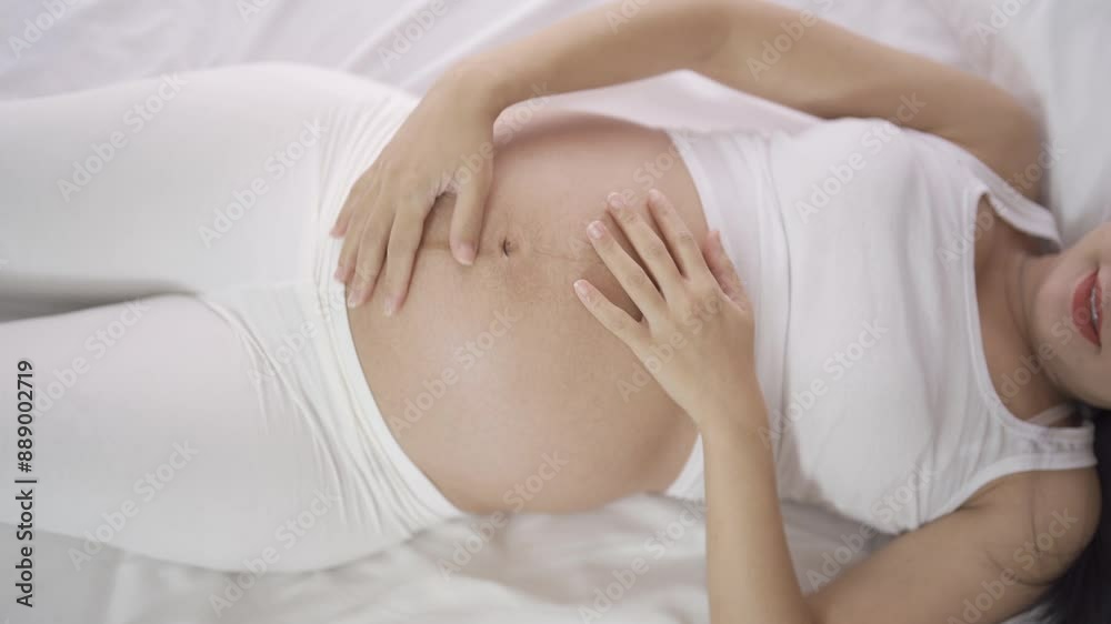 A Portrait of happy Asian pregnant woman in bedroom at home. Having a baby. Family people lifestyle. Love. A Portrait of happy Asian pregnant woman in bedroom at home. Having a baby. Family people lifestyle. Love.