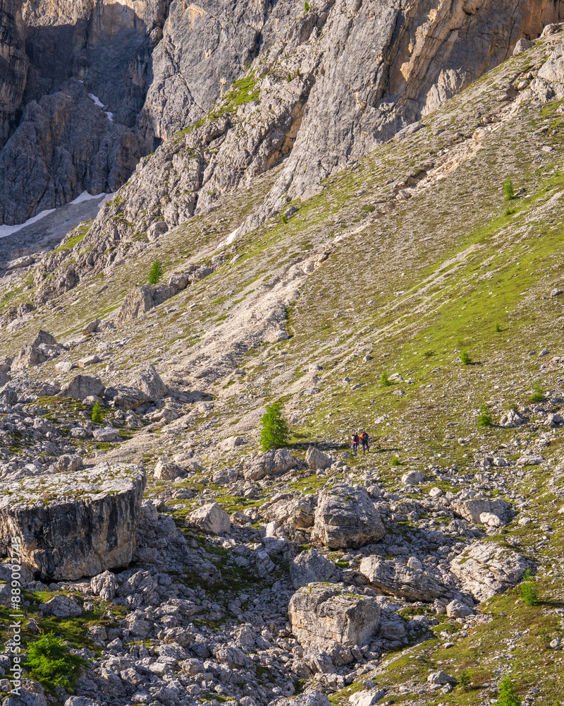 Huge rocks, the Dolomites and in the distance two climbers are walking, slowly ascending the mountains to climb. Beauty of nature. Dolomites, Italy Huge rocks, the Dolomites and in the distance two climbers are walking, slowly ascending the mountains to climb. Beauty of nature. Dolomites, Italy