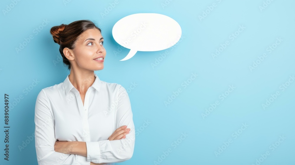 Whiteshirted woman gazing thoughtfully with empty speech bubble on blue backdrop, conveying ideas and thoughts. Whiteshirted woman gazing thoughtfully with empty speech bubble on blue backdrop, conveying ideas and thoughts.