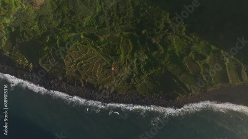 Aerial view of black sand beach and cliff at sunrise, Lajes das Flores, Azores, Portugal. photo