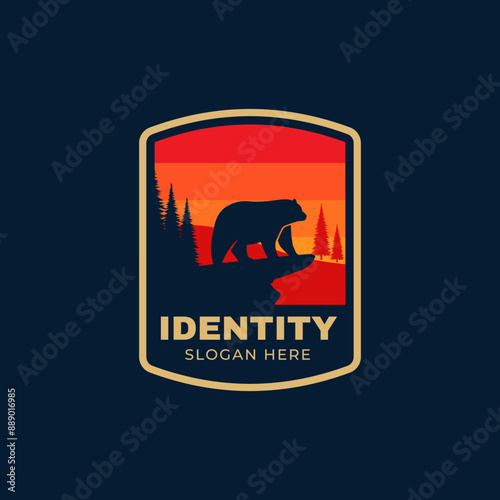 a bear enjoying the sunset on the edge of a cliff