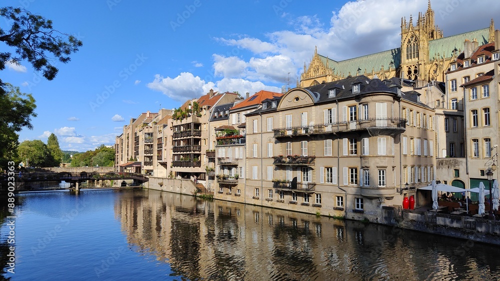 Obraz premium Moselle river in Metz, France. Blue sky, white clouds.