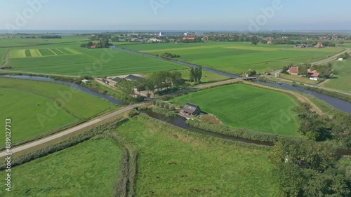 Aerial view of beautiful countryside with farm, river, and road, Allingawier, Friesland, Netherlands. photo