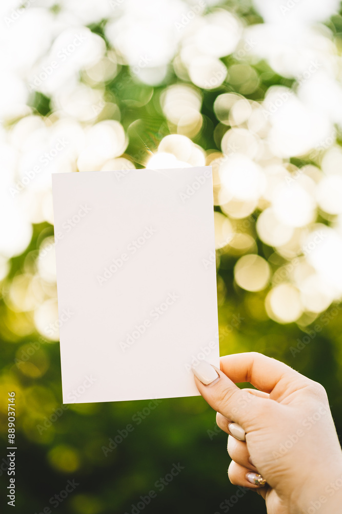 Paper empty blank background backdrop against garden bokeh. Copy space Handicraft. Frame design background Paper empty blank background backdrop against garden bokeh. Copy space Handicraft. Frame design background