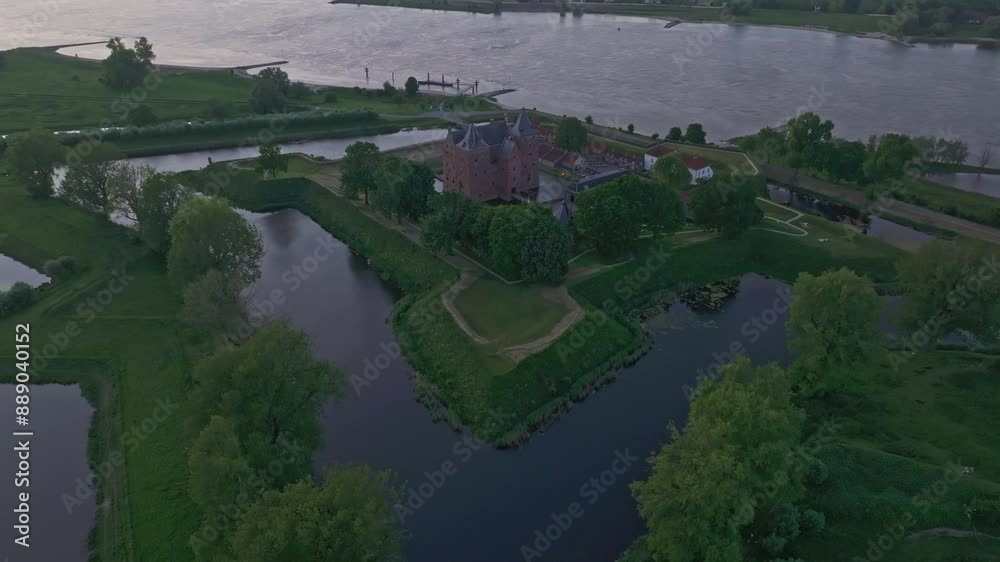 Aerial view of medieval castle fortress with river and greenery at sunset, Slot Loevestein, Netherlands. Aerial view of medieval castle fortress with river and greenery at sunset, Slot Loevestein, Netherlands.