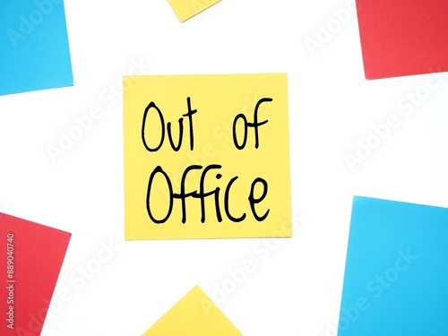 A yellow sticky note with the handwritten text Out of office in black letters. Is it correct: out-of-office message on a paper note