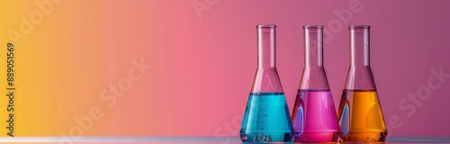 Four Glass Flasks Filled With Colorful Liquids Against Pink Background