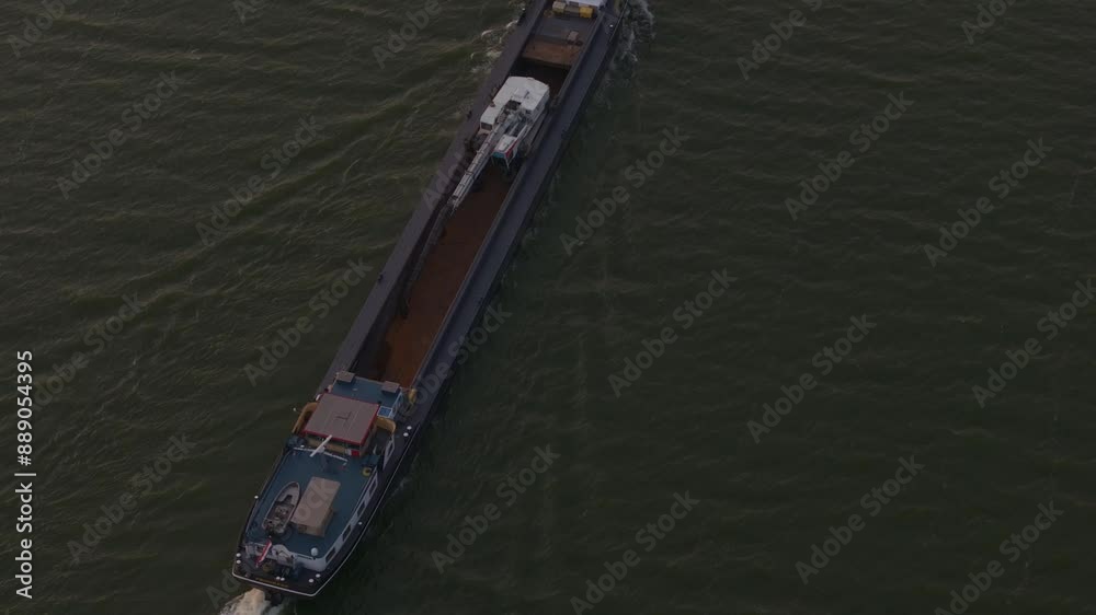 Aerial view of cargo vessel on lake at sunset, Ijsselmeer, Friesland, Netherlands. Aerial view of cargo vessel on lake at sunset, Ijsselmeer, Friesland, Netherlands.
