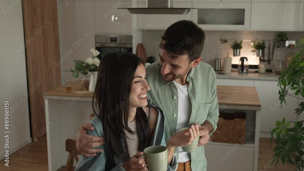 Boyfriend and girlfriend enjoy their first morning coffee at kitchen Boyfriend and girlfriend enjoy their first morning coffee at kitchen